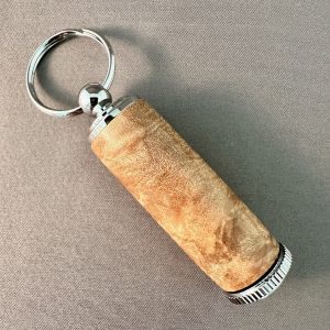 Opposite side of hand-turned maple burl pill holder showing natural wood figure