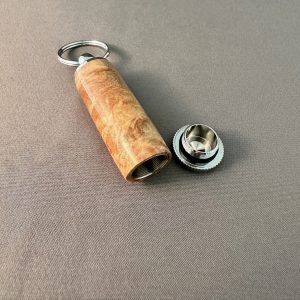 Open maple burl pill holder keychain with screw cap removed