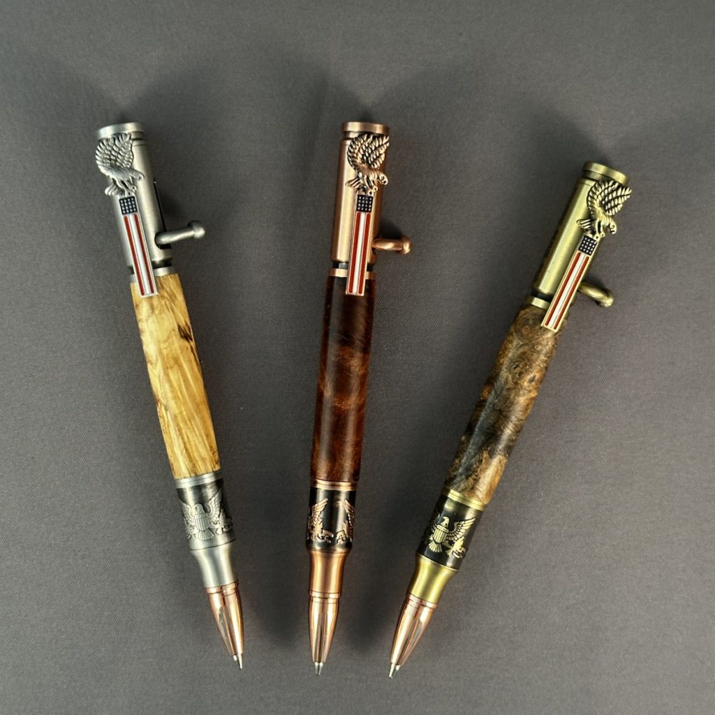 Three handcrafted Bald Eagle bolt-action pens shown straight on