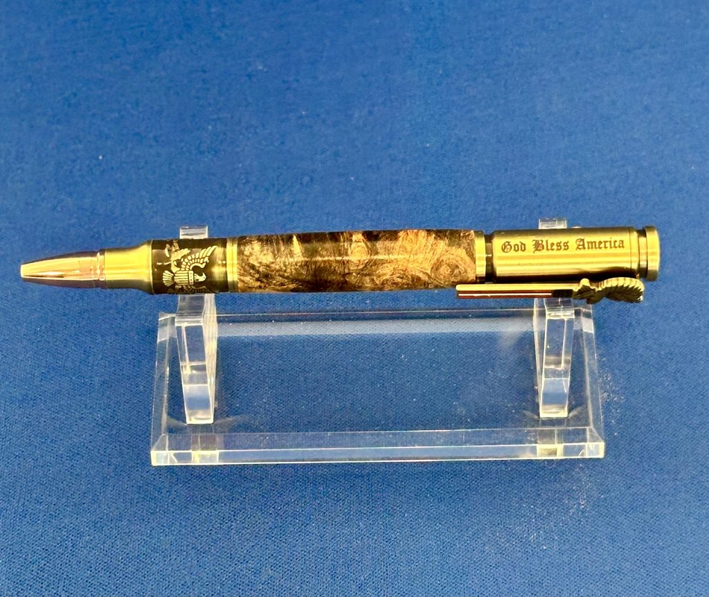 Handcrafted wooden pen with gold-tone hardware displayed on a clear stand