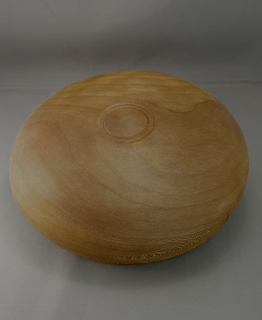 Underside of hand-turned Sycamore calabash bowl showing the rounded base and wood grain