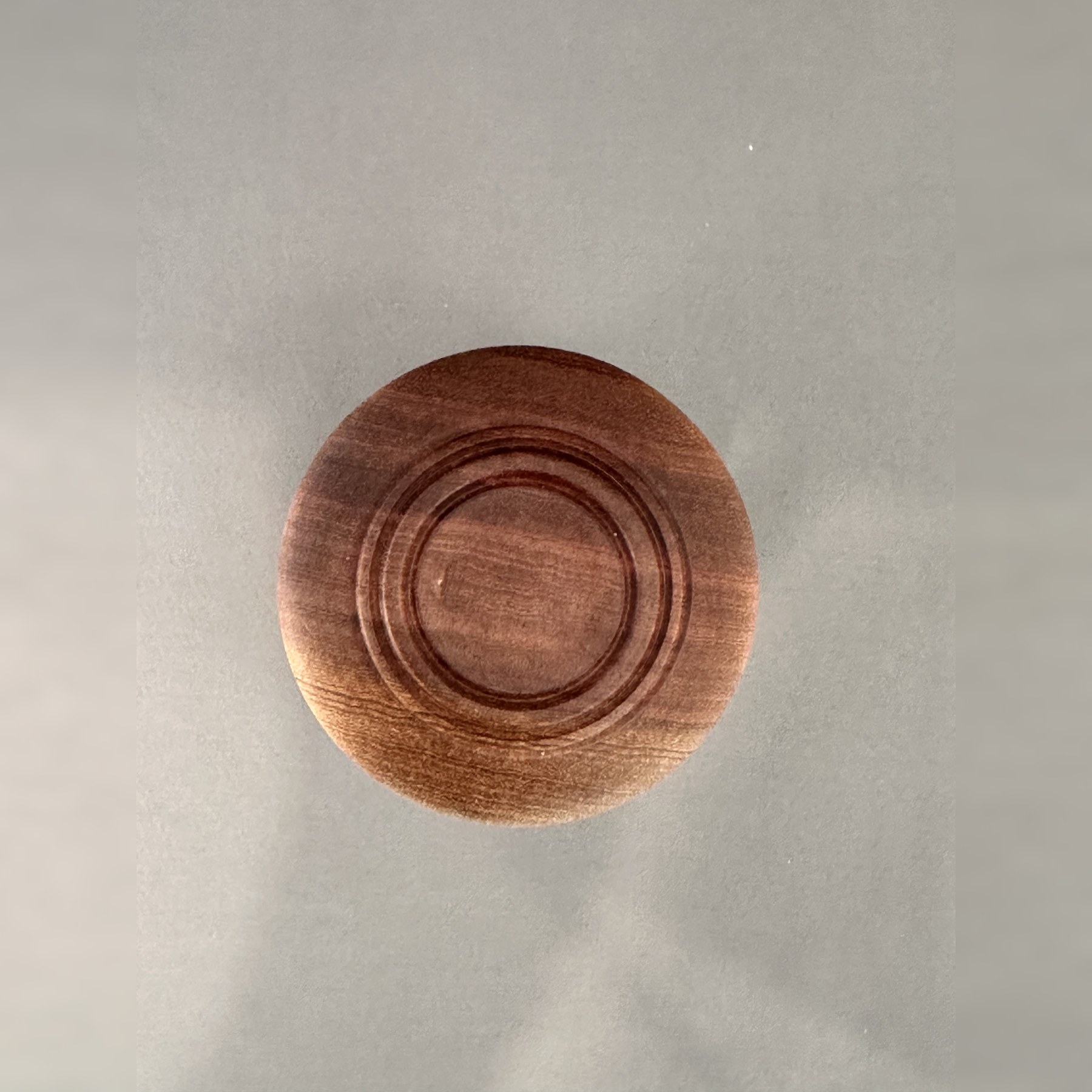 Top view of the Sipo mahogany lid with concentric turned-ring details