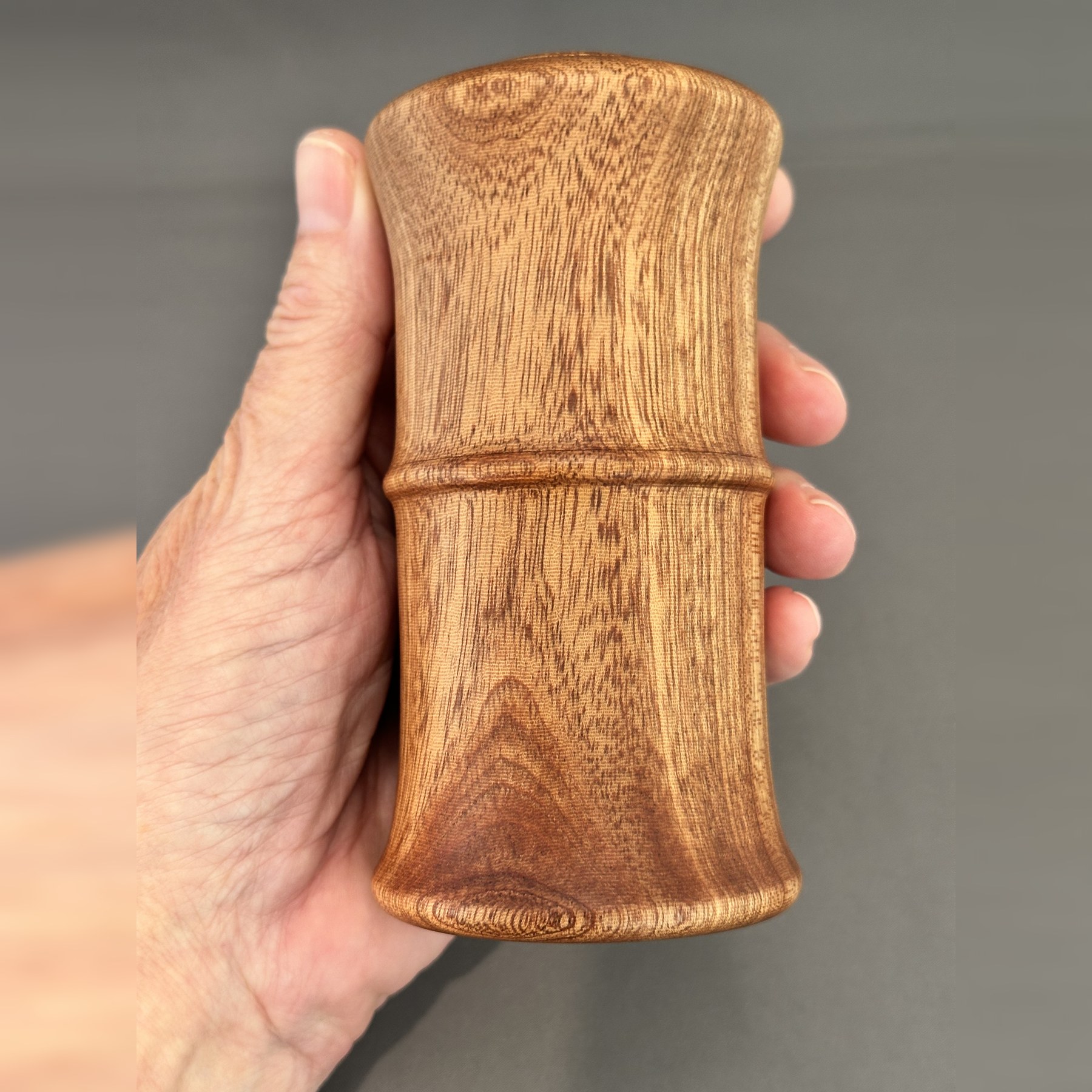 Sipo mahogany keepsake box held in one hand to show its size and grain