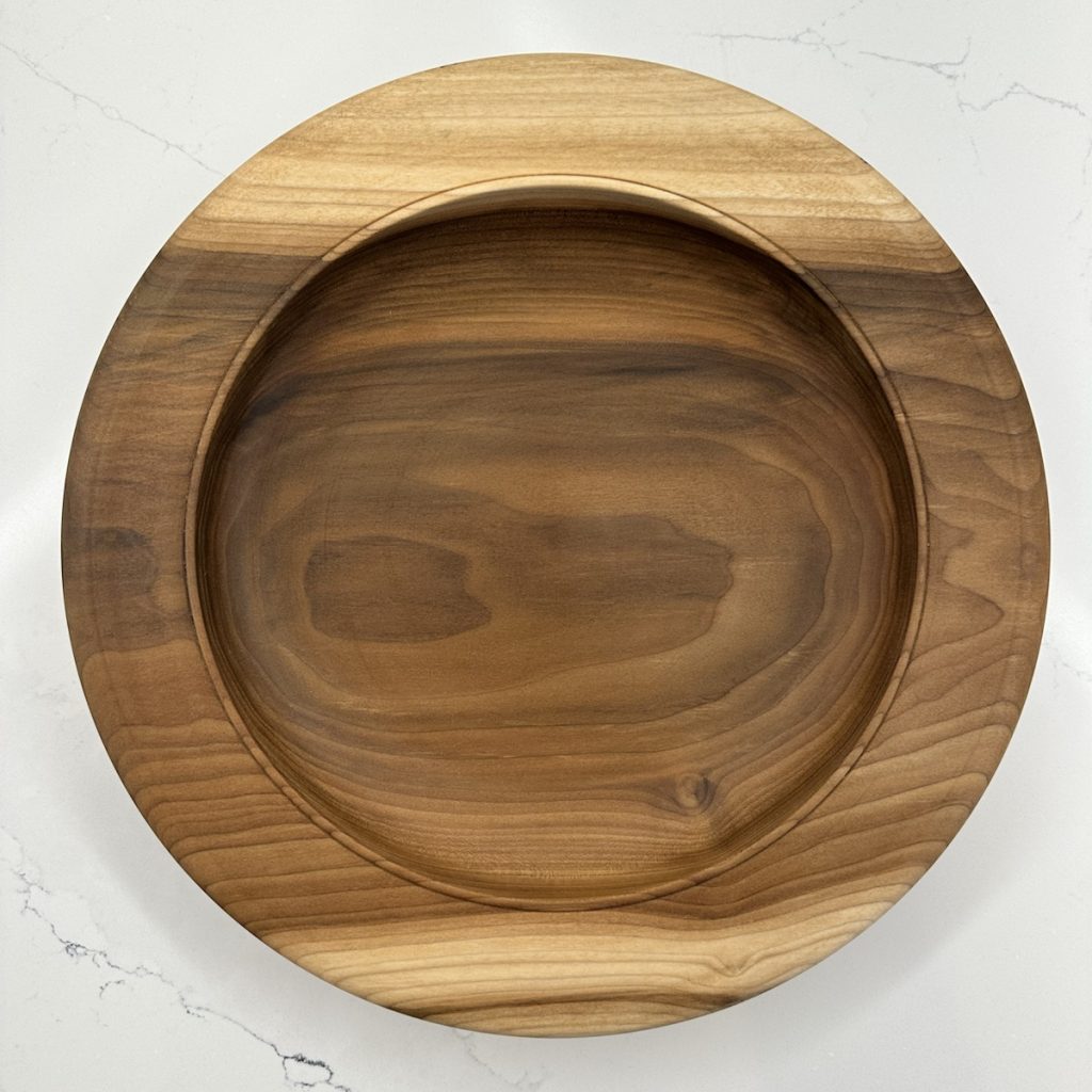 Top view of Horizon Within, a shallow rainbow poplar bowl with a wide rim and contrasting grain.