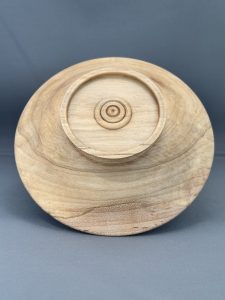 Underside of the maple bowl Quiet Center showing its raised foot and decorative rings