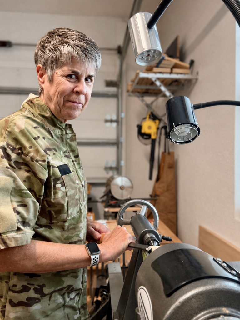 Rogene Sears working at a woodturning lathe