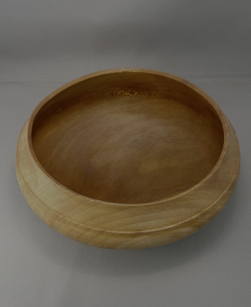 Sycamore calabash bowl showing the hand-turned interior and natural wood grain