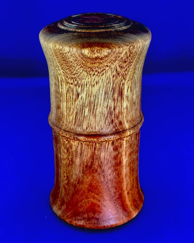 Inner Sanctuary against a blue background, showing its flared profile, flowing grain, raised bead, and concentric lid details.