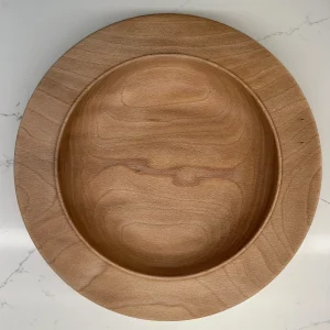 Interior view of a sycamore bowl showing warm brown grain patterns framed by a broad, pale rim.